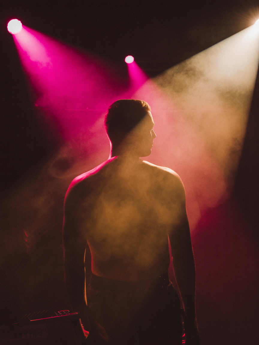 Editorial cinematic performer under warm stage light — VIQMEDIA talent management